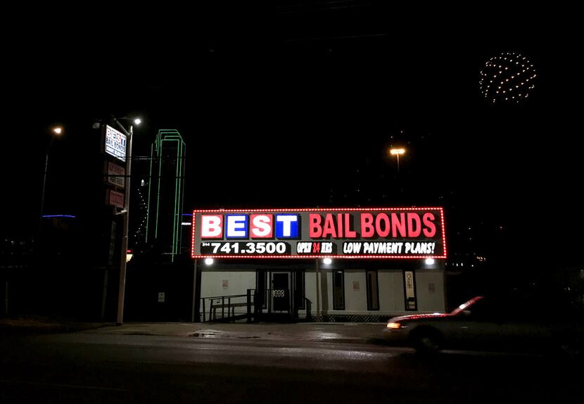 Lights from a bail bond business glow along Riverfront Boulevard in Dallas. Four nonprofits...