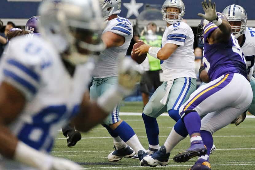 Dallas Cowboys quarterback Tony Romo (9) looks downfield for a receiver in the fourth...