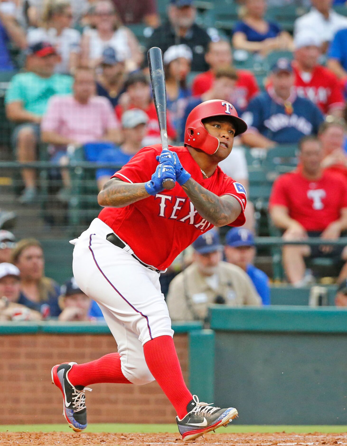 Texas Rangers designated hitter Willie Calhoun (5) singles in a run in the second inning...