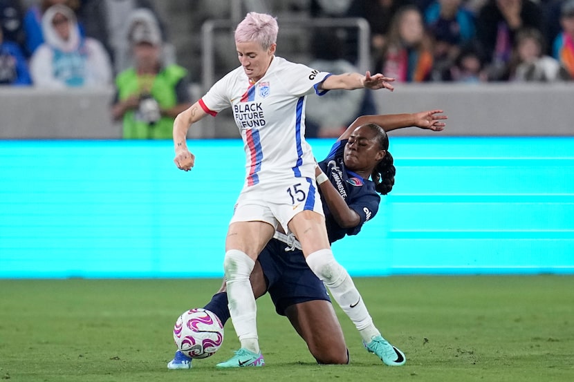 OL Reign forward Megan Rapinoe, left, battles San Diego Wave forward Jaedyn Shaw for the...