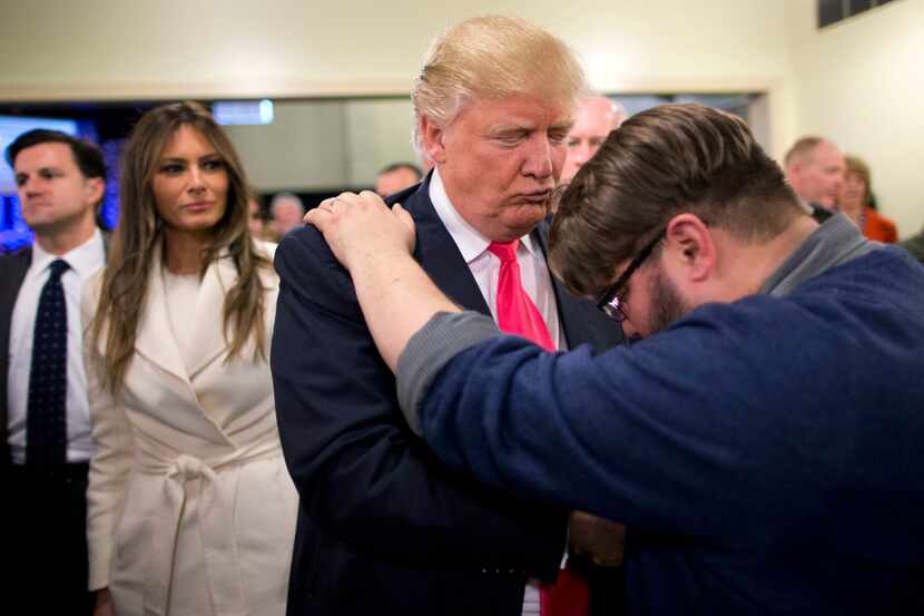 In this Jan. 31, 2016, file photo, Pastor Joshua Nink, right, prays for Republican...