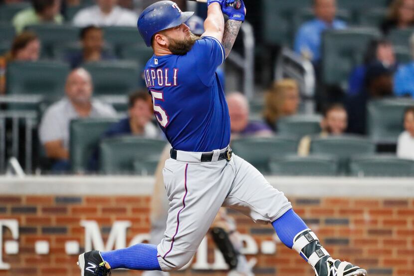 Texas Rangers pinch-hitter Mike Napoli hits a single during the ninth inning of the second...