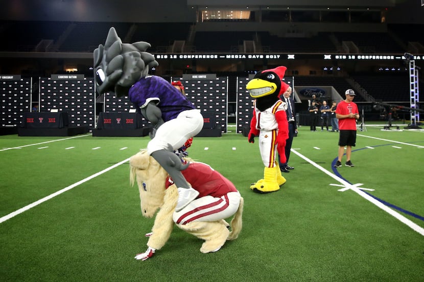 TCU mascot SuperFrog plays leap frog with Oklahoma mascot Boomer during the Big 12 Football...
