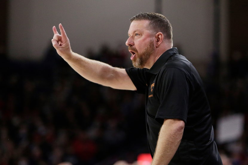 Texas coach Chris Beard directs players during the first half of an NCAA college basketball...