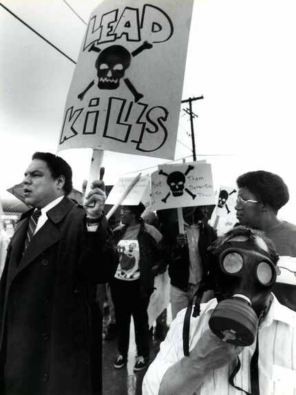 In March 1991, protestors march past industrial sites on Singleton Boulevard in West Dallas...