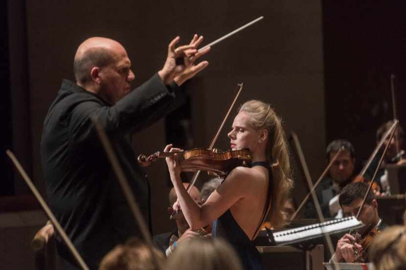 Led by Conductor Jaap Van Sweden, left, Violinist Simone Lamsma performs with the Dallas...