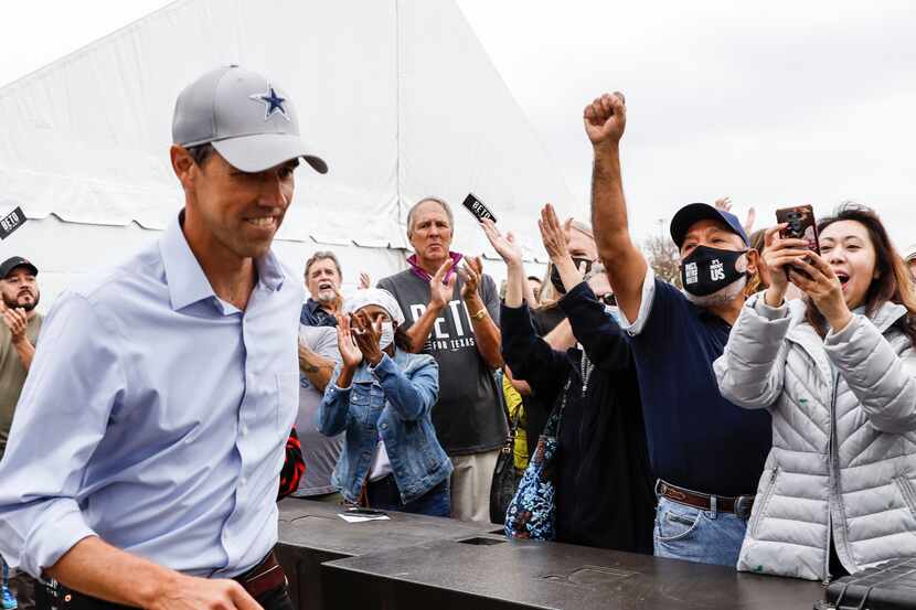 Beto O'Rourke runs onto the stage past supporters during a rally in Dallas on Sunday, Nov....