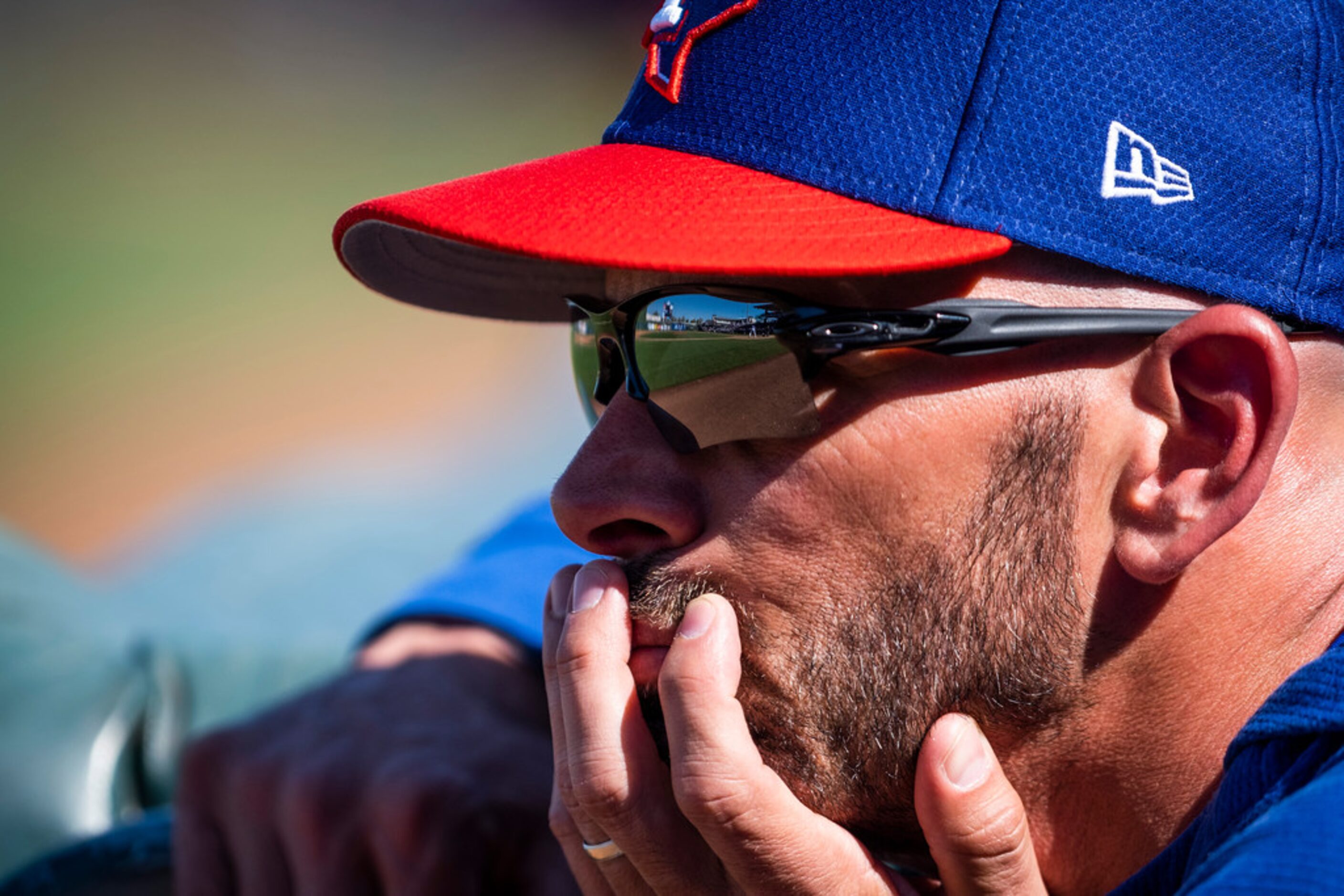 Texas Rangers manager Chris Woodward watches from the dugout during the fifth inning of a...