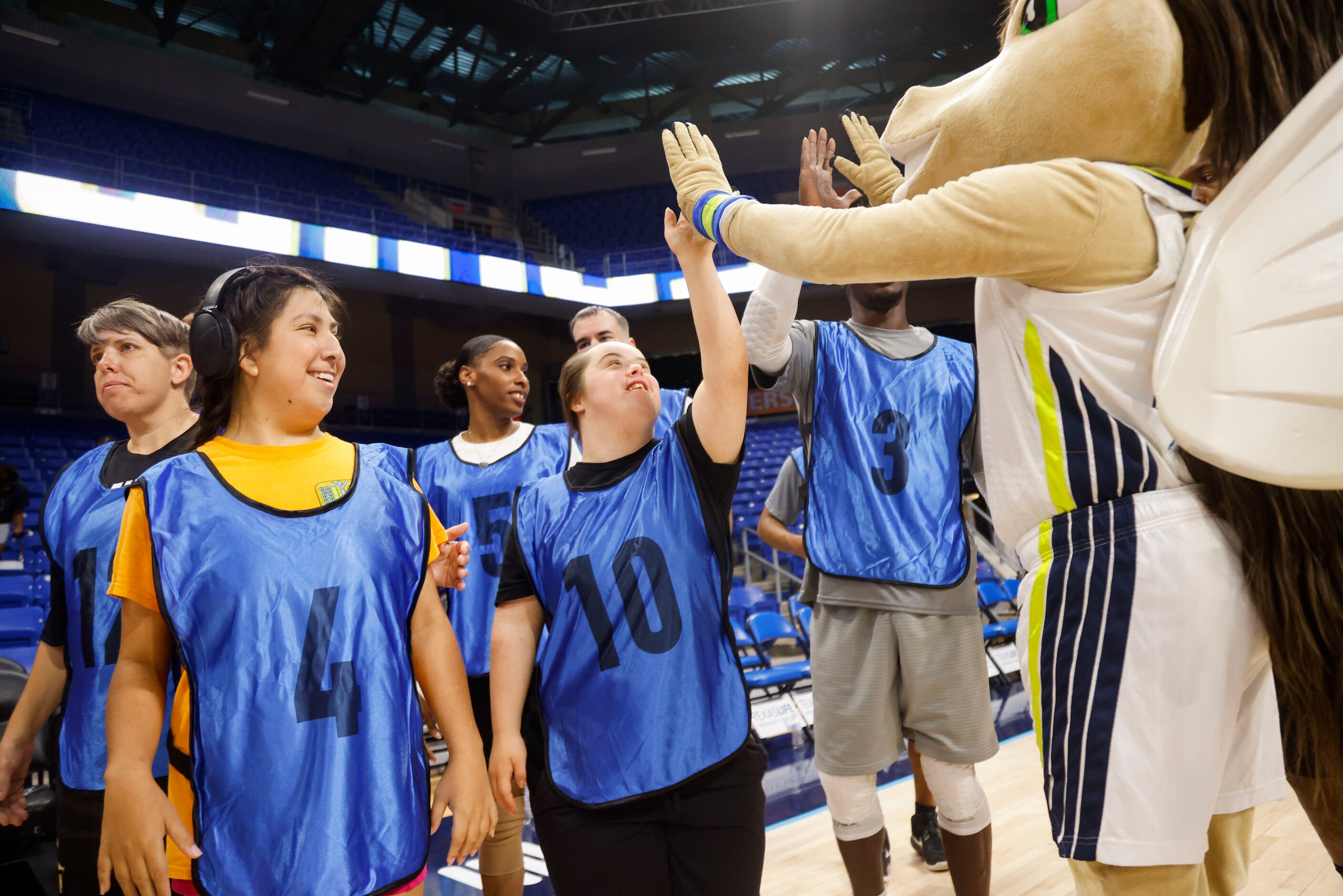 Team Arike’s Marissa Webb (10) high-fives Dallas Wing’s Lightning after her team won the...