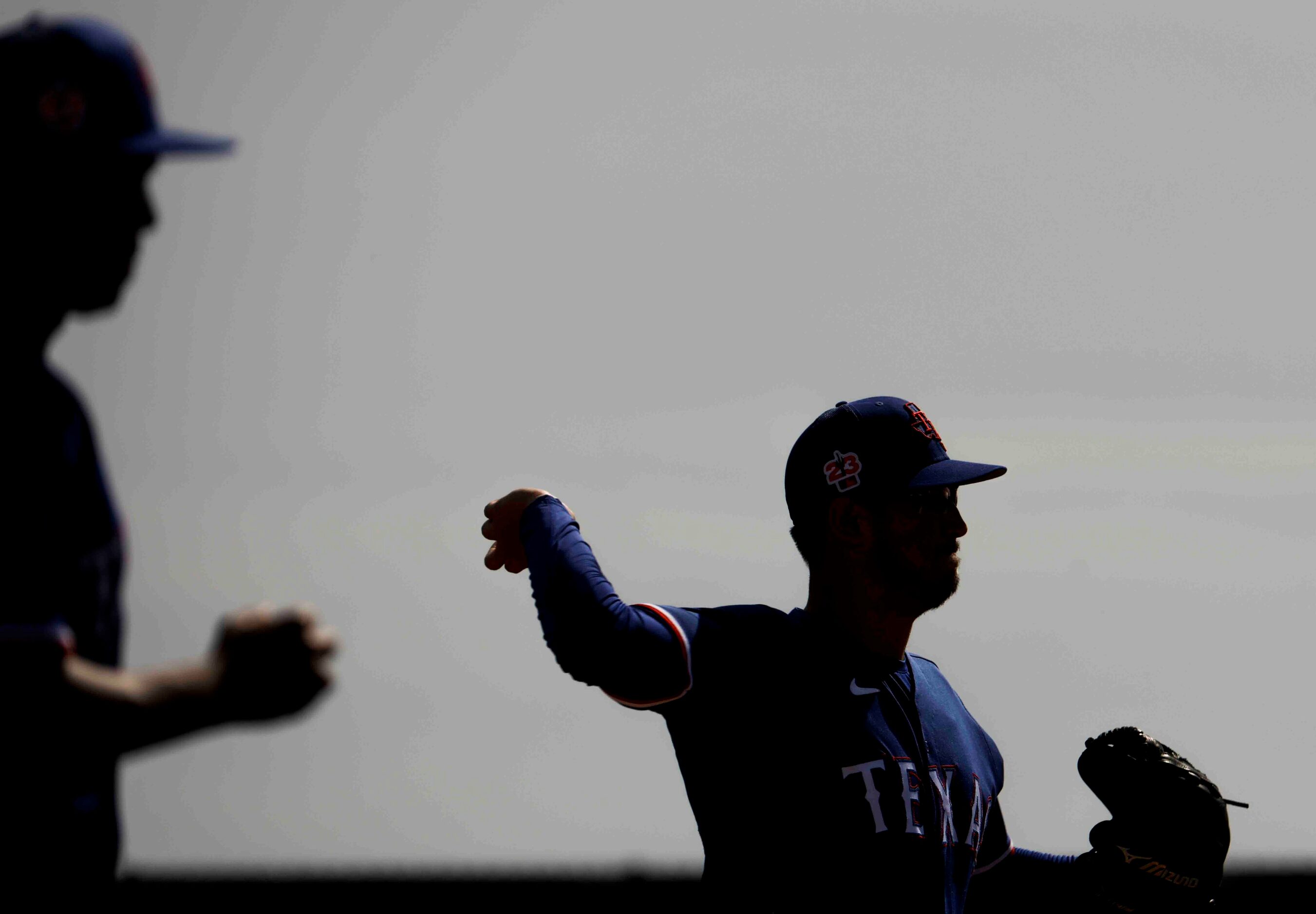 Texas Rangers pitcher Dane Dunning throws the ball while taking part in a drill during a...