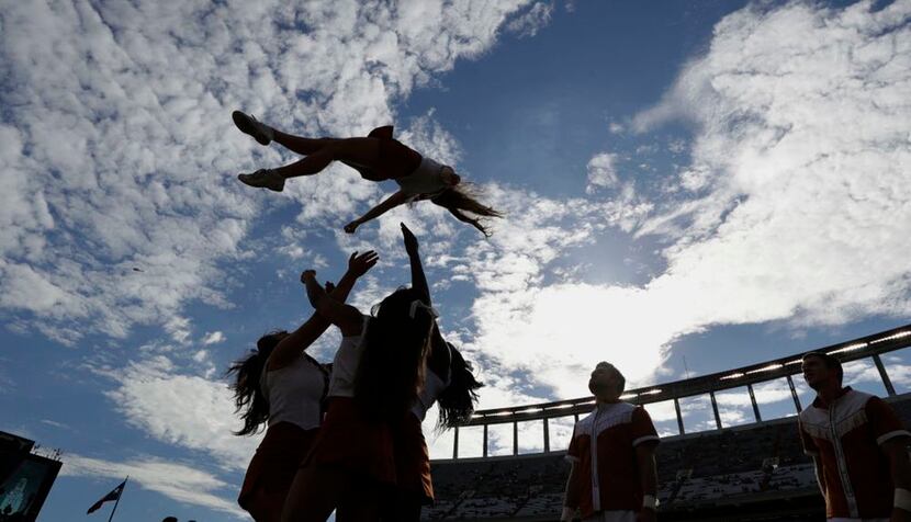 A Texas cheerleader is tossed in the air prior to a NCAA college football game against UTEP,...