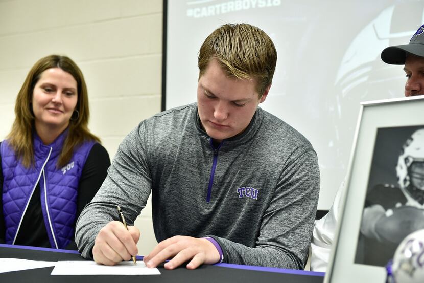 Guyer senior offensive lineman John Lanz signs his national letter of intent to play...