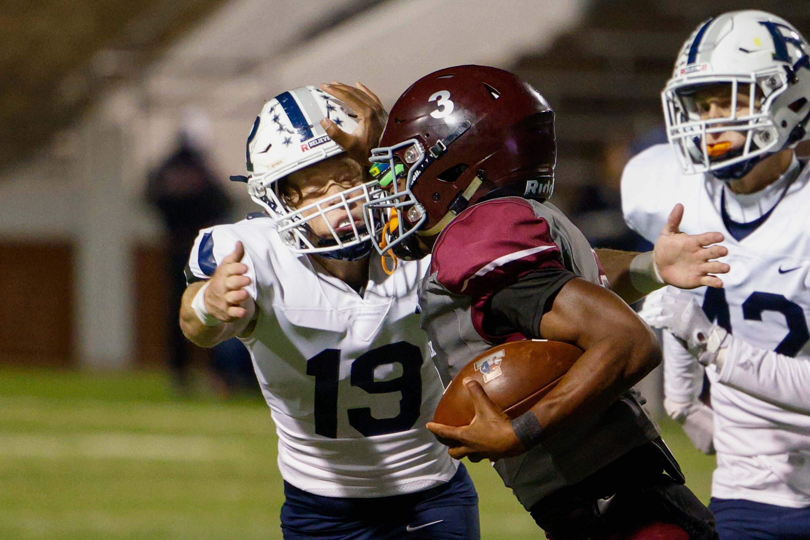 Mansfield Timberview quarterback Cameron Bates (3) stiff-arms Richland defensive back Gaven...