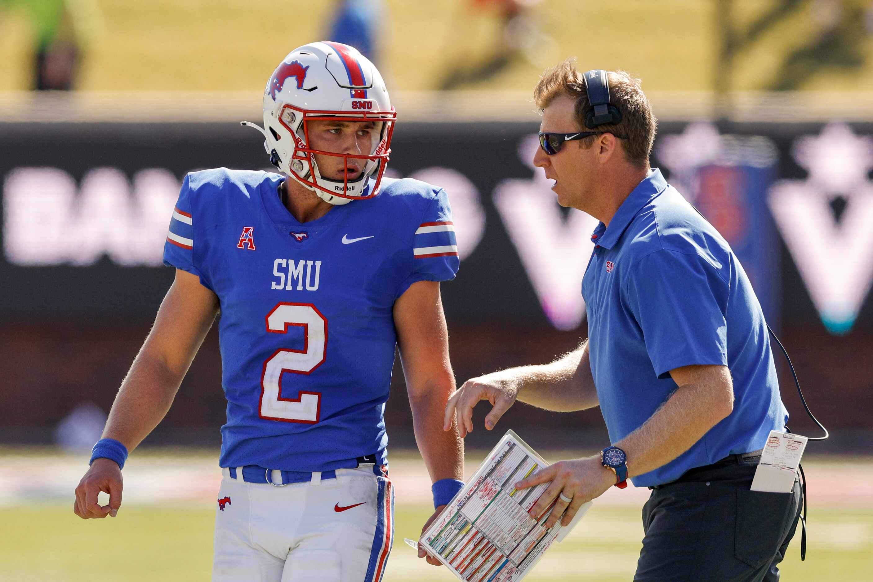 SMU head coach Rhett Lashlee talks with quarterback Preston Stone (2) during the second half...