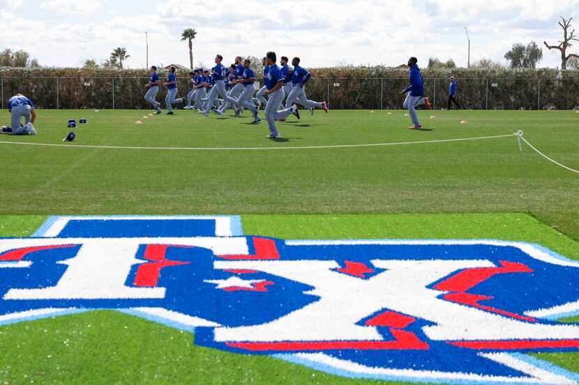 Texas Rangers minor league players jog during a spring training workout at the team’s...