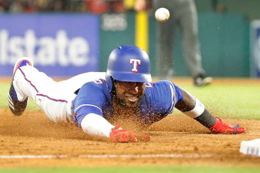 Texas Rangers shortstop Jurickson Profar (19) advances to third on a fly ball out in the...