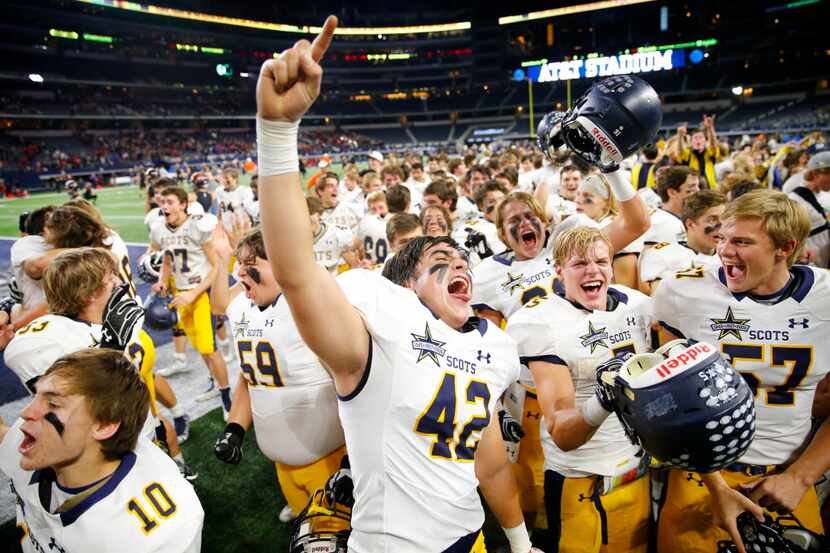 Highland Park's Max Holsomback (42) celebrates with teammates following their 14-7 win over...