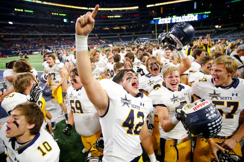Highland Park's Max Holsomback (42) celebrates with teammates following their 14-7 win over...