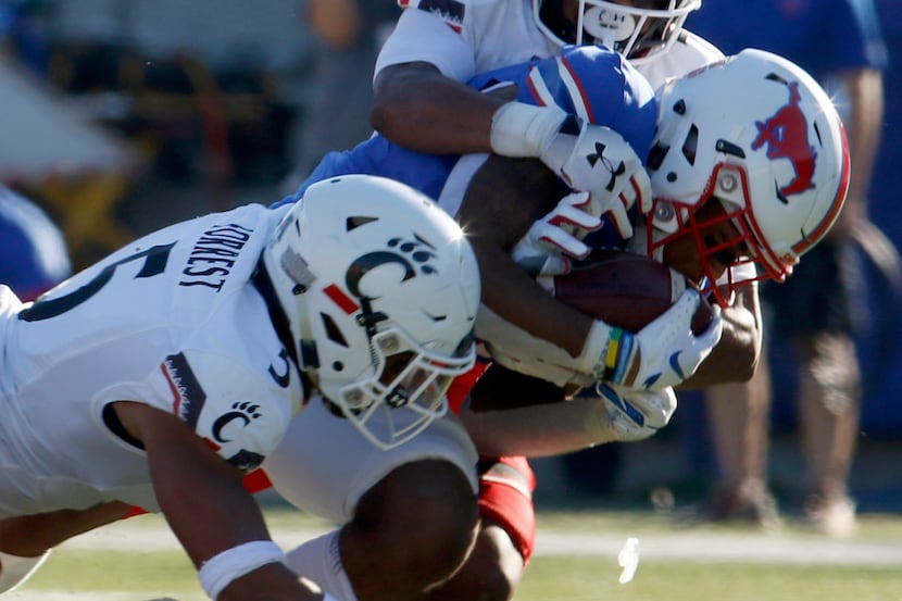 SMU receiver Reggie Roberson,Jr. secures the ball as he pulls in a 42-yard reception while...