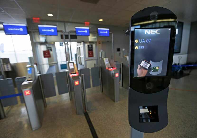 A facial recognition device is ready to scan another passenger at George Bush...