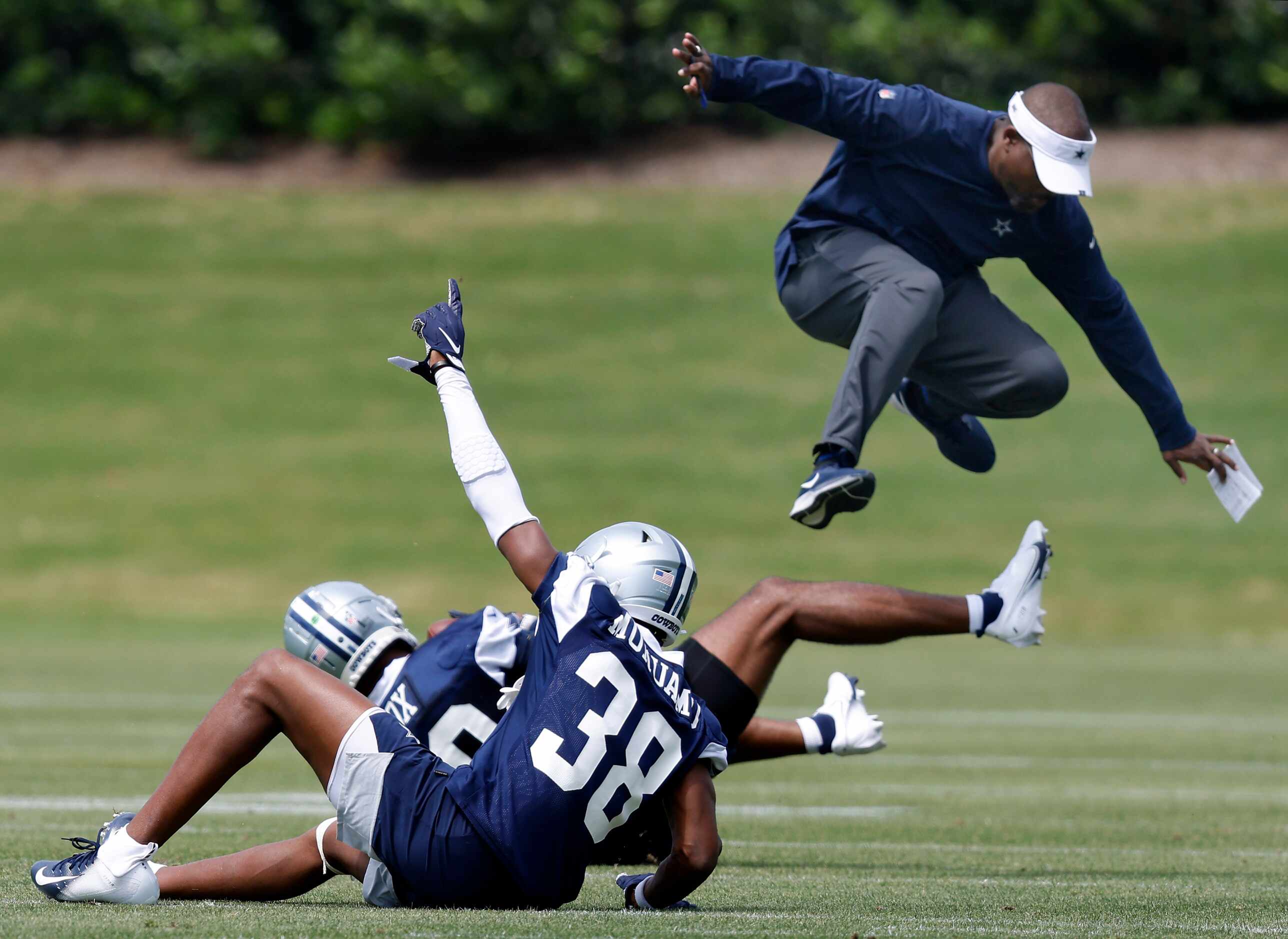 Dallas Cowboys secondary coach Joe Whitt Jr leaps out of the way after rookie linebacker...