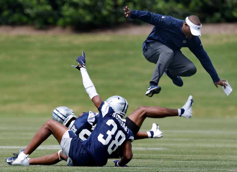 Dallas Cowboys secondary coach Joe Whitt Jr. leaps out of the way after rookie linebacker...
