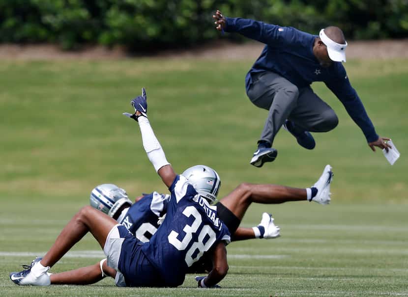 Dallas Cowboys secondary coach Joe Whitt Jr. leaps out of the way after rookie linebacker...