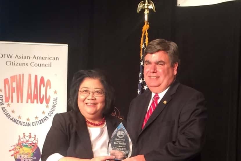 DFW AACC Chair Marian Gallemore presents an award to Richardson Mayor Paul Voelker for his...