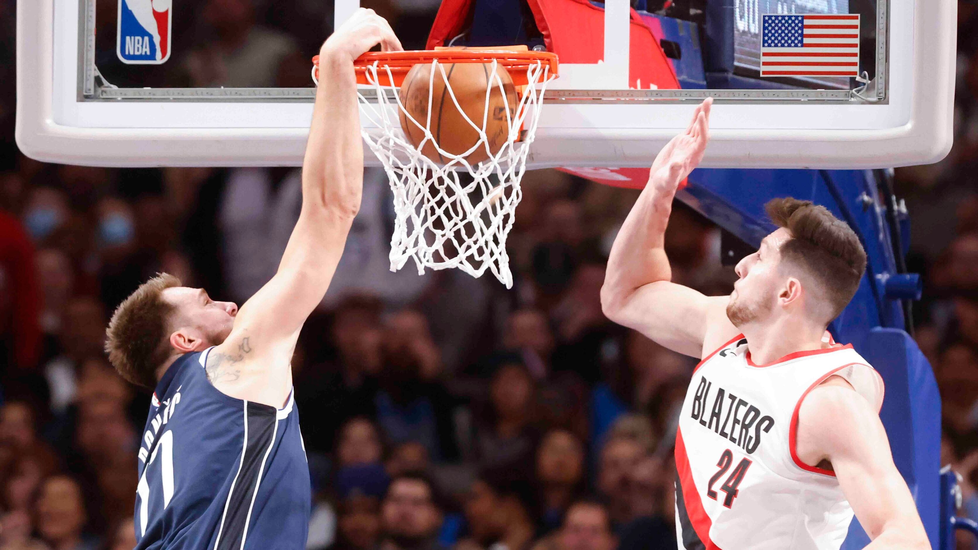 Dallas Mavericks guard Luka Doncic (77) dunks past Portland Trail Blazers forward Drew...