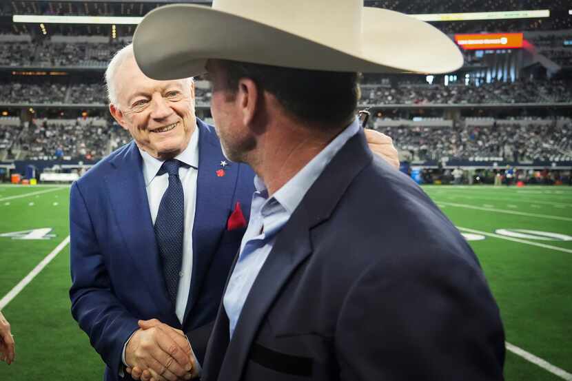 Dallas Cowboys owner and general manager Jerry Jones shakes hands with Taylor Sheridan...