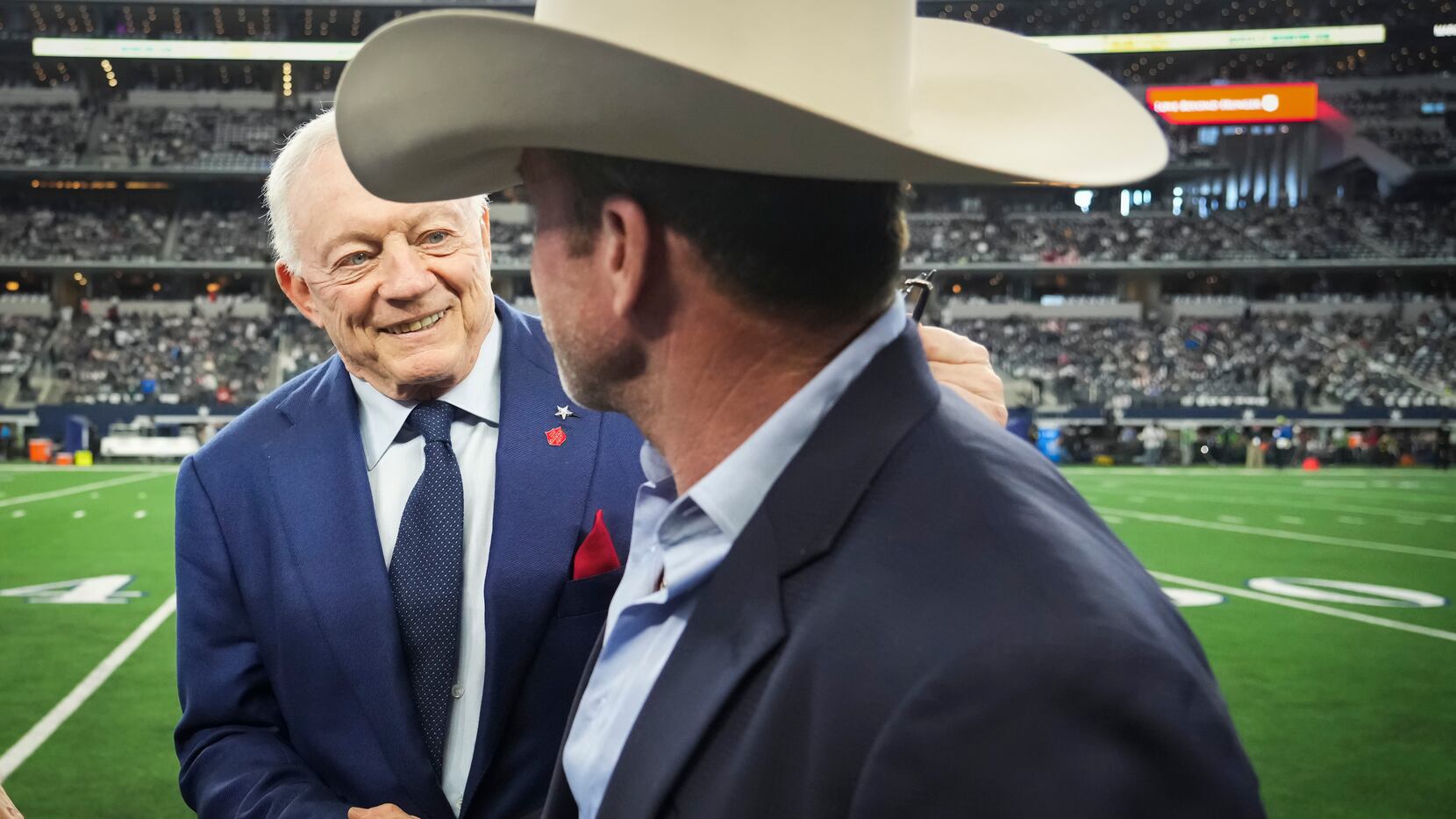 Dallas Cowboys owner and general manager Jerry Jones shakes hands with Taylor Sheridan...