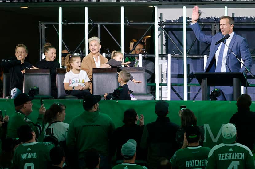 Dallas Stars legend Mike Modano waves during the unveiling ceremony of his statue at the...