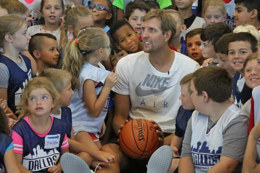 Dirk Nowitzki visits with the youngsters before posing for a photo with the kids attending...