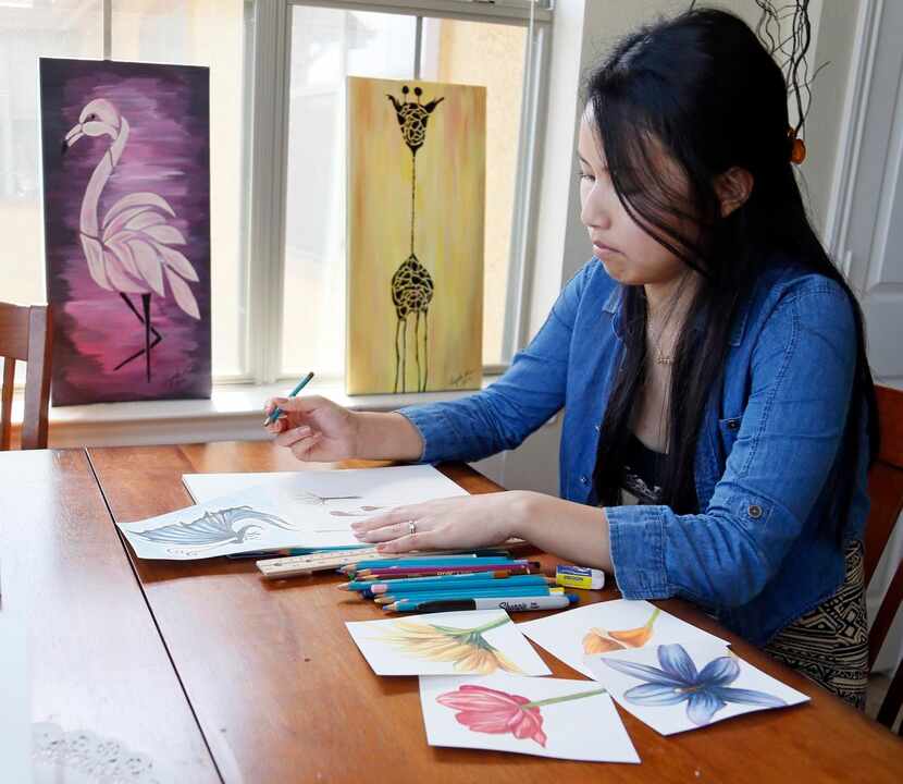 Angela Kim makes a hand-painted card at her home in Corinth.