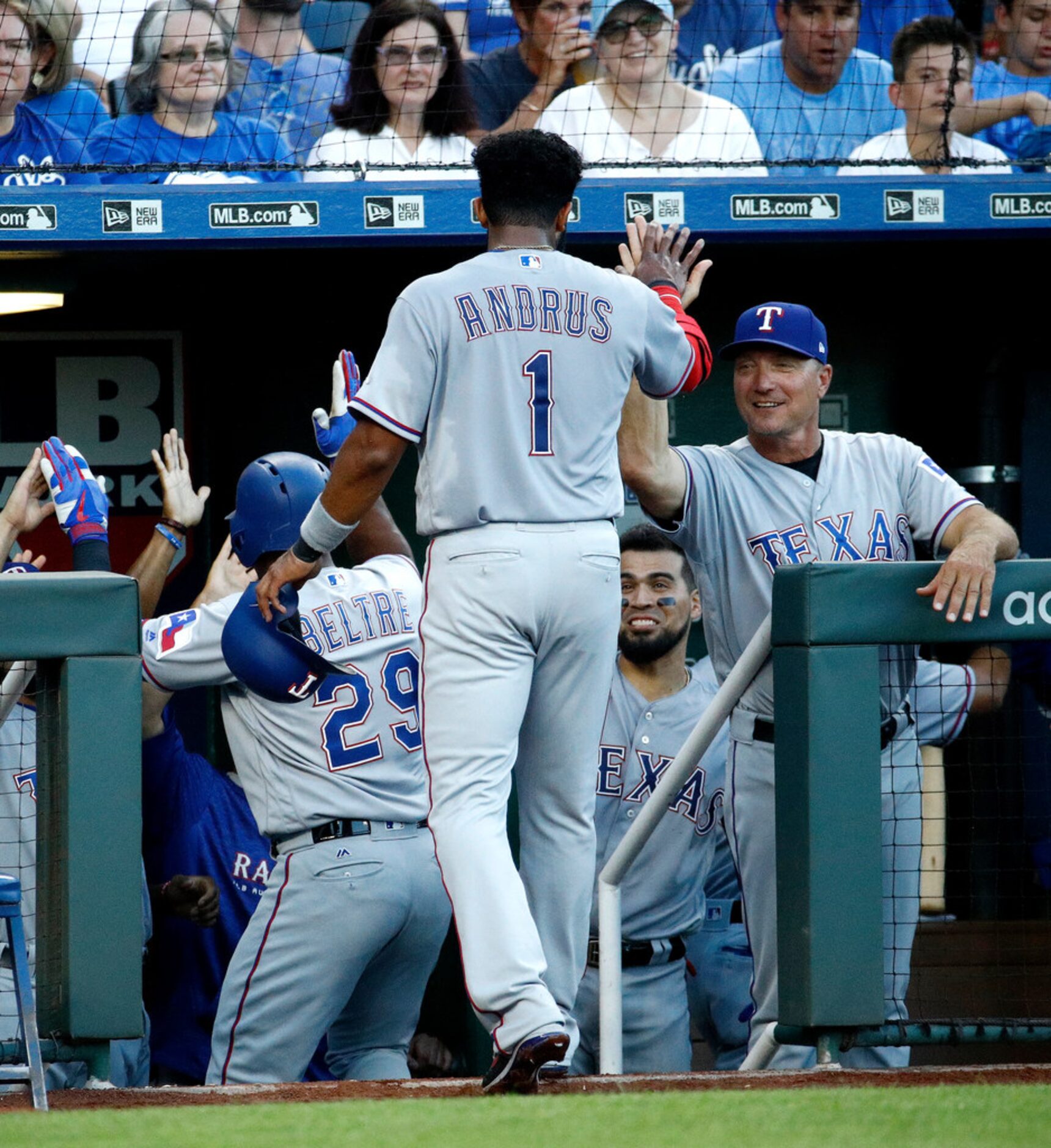 Texas Rangers' Elvis Andrus (1) celebrates with manager Jeff Banister, right, as he comes...