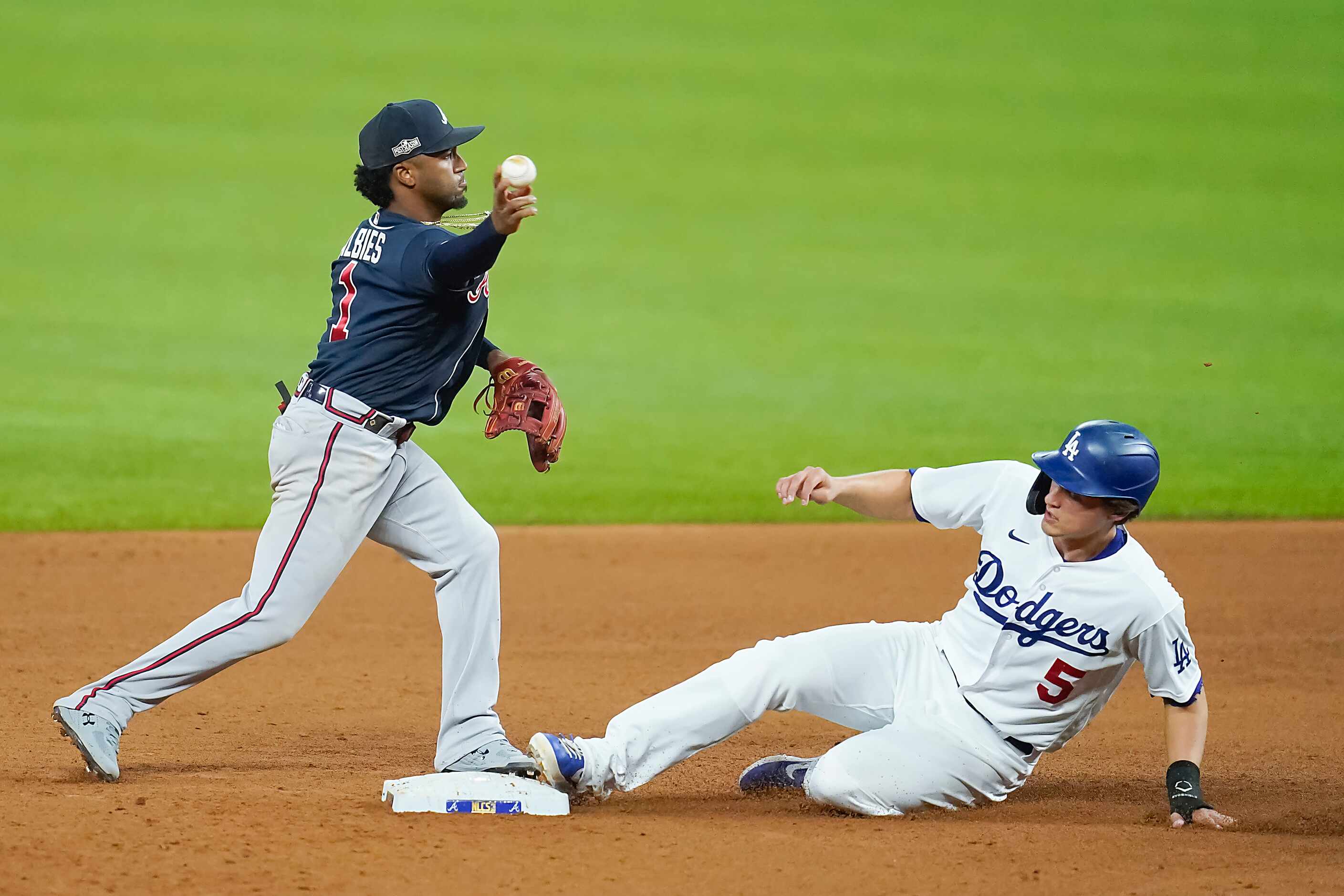 Atlanta Braves second baseman Ozzie Albies (1) makes the relay over Los Angeles Dodgers...