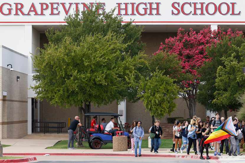 Dozens of Grapevine High School students walk out of their classroom to participate in a...