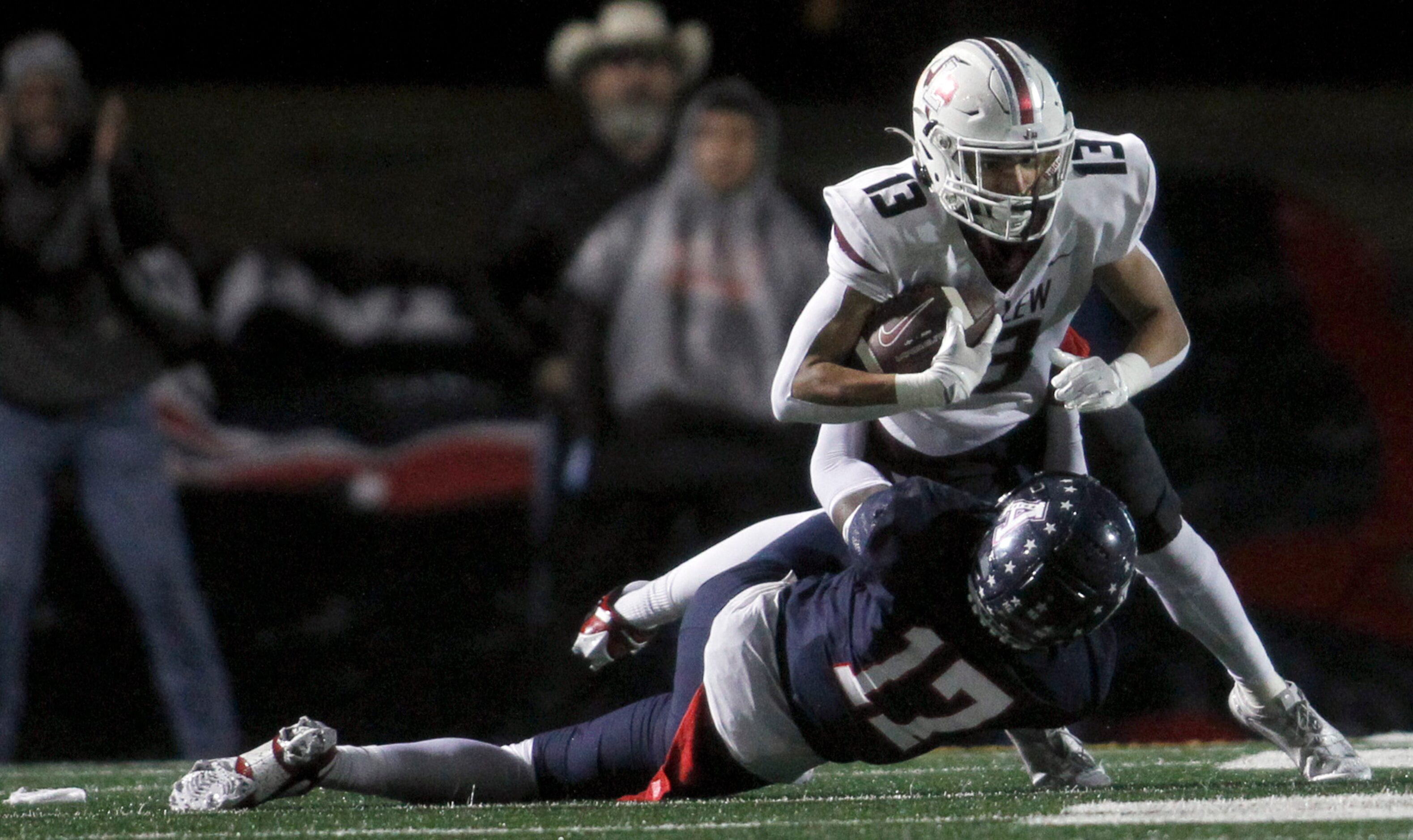 Lewisville receiver JJ Gonzales (13) is unable to escape the tackle of Allen defensive back...