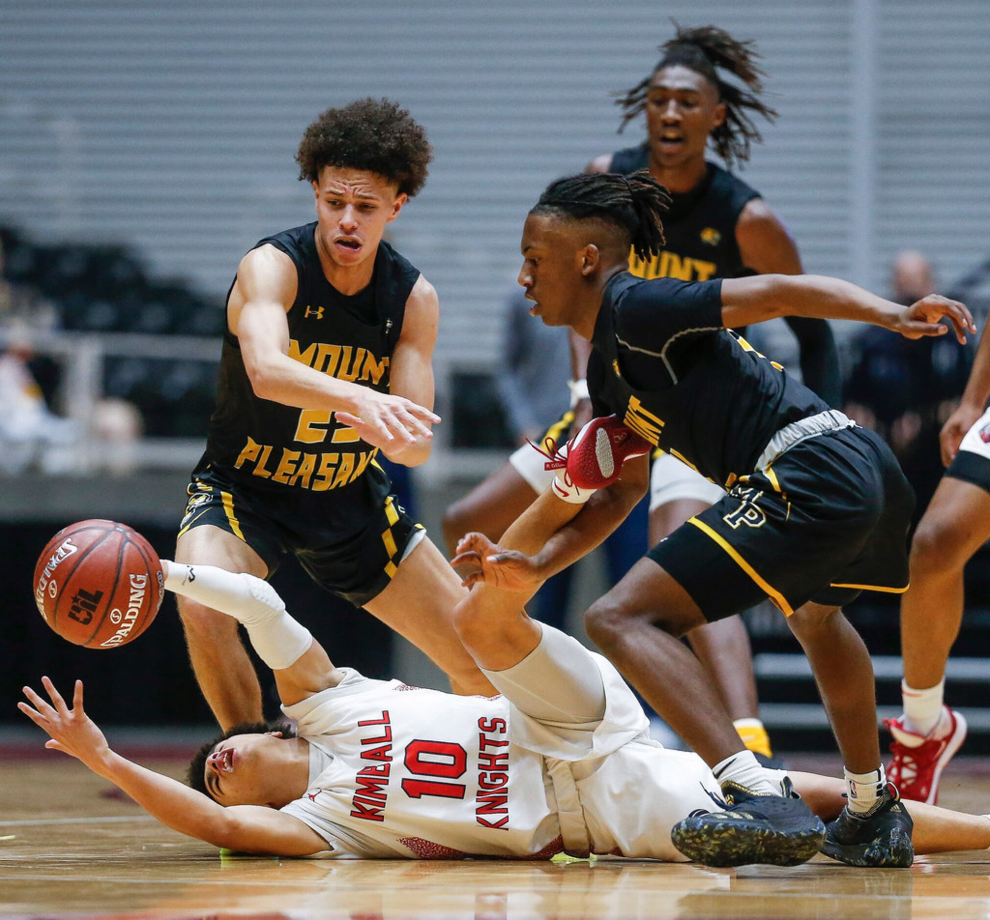 Kimball's Jayden Blair (10) reaches to recover a loose ball against Mount Pleasant's Payton...