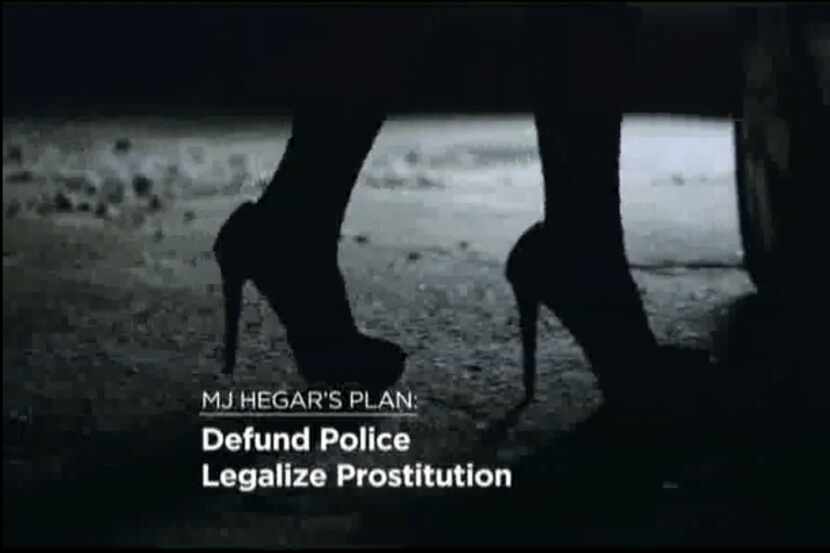 A frame grab from a 30-second Cornyn campaign spot shows a woman in high heels, presumably a...