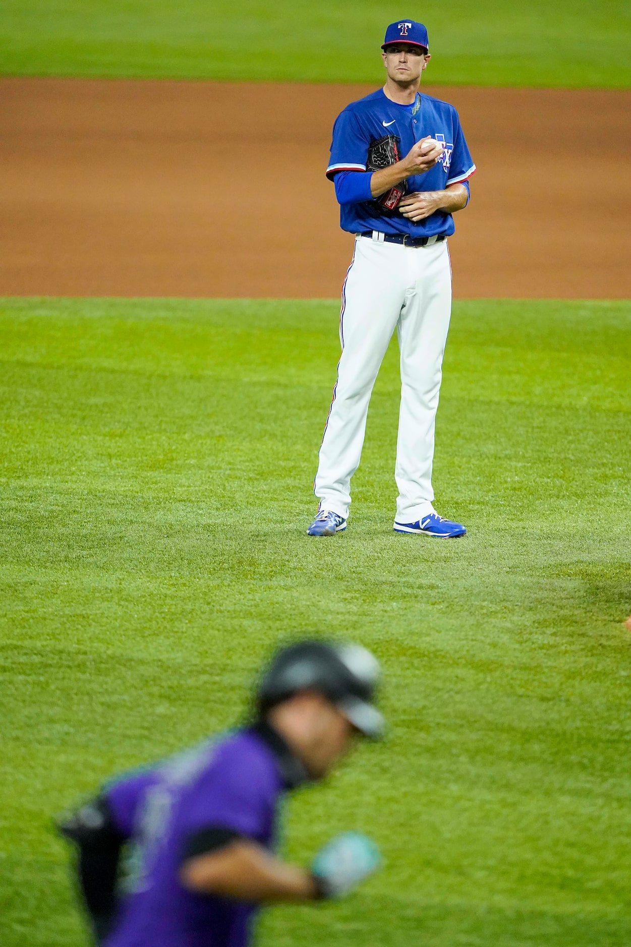 Texas Rangers pitcher Kyle Gibson watches Colorado Rockies third baseman Nolan Arenado round...