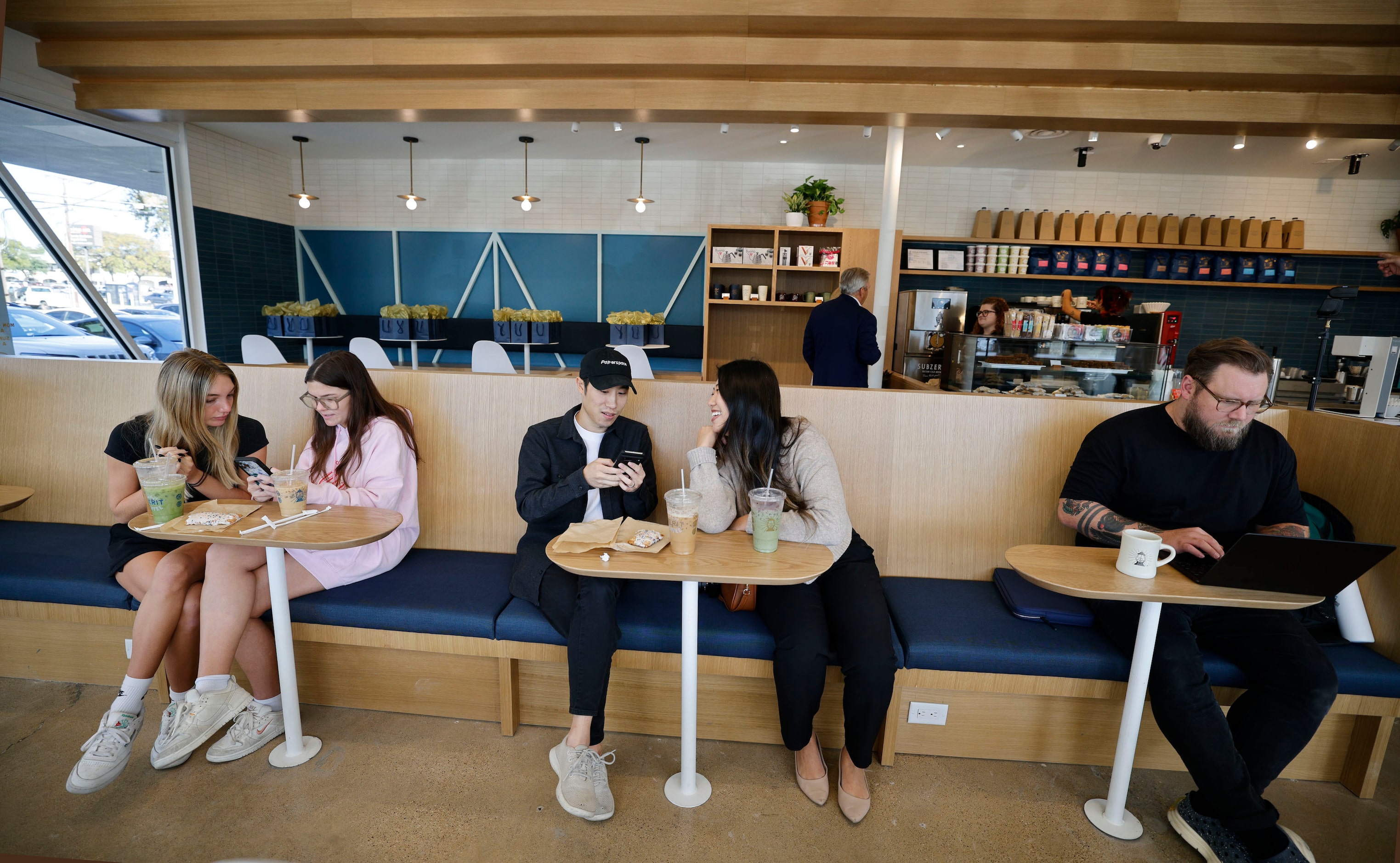 People attend a soft opening of a new Merit Coffee shop at 4124 Abrams Road, Thursday, Oct....