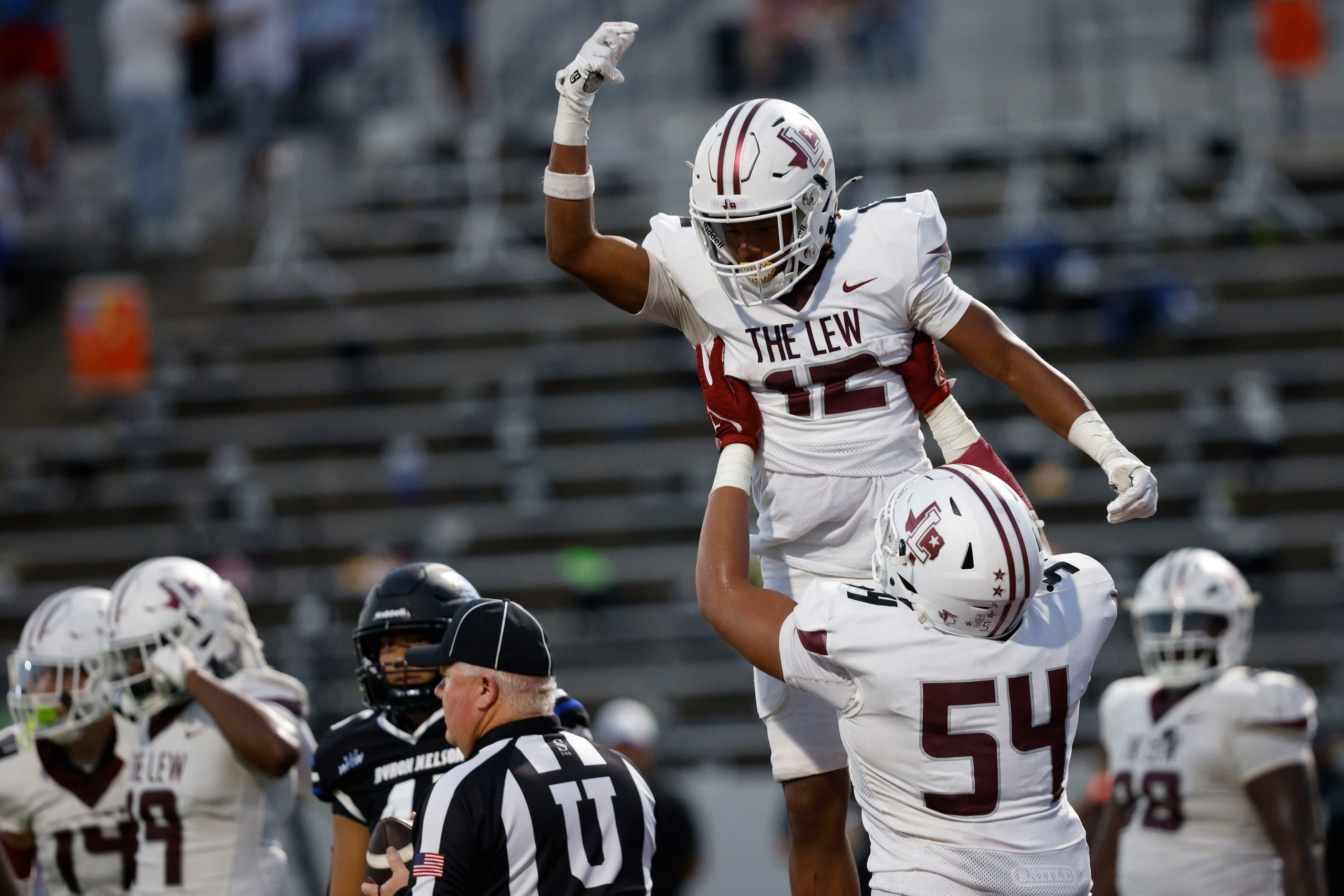 Lewisville's Derrick Martin (12) is congratulated by Lewisville's Maxx Jones after scoring a...