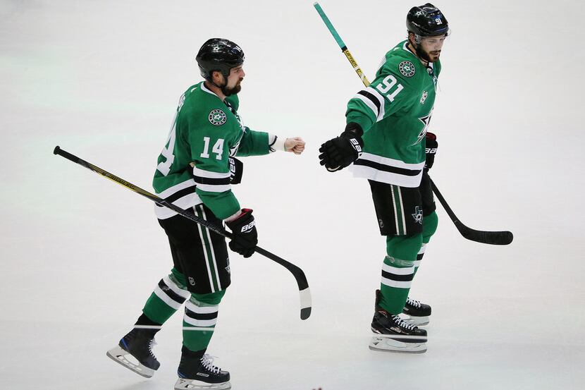 Dallas Stars left wing Jamie Benn (14) is congratulated by center Tyler Seguin (91) after...