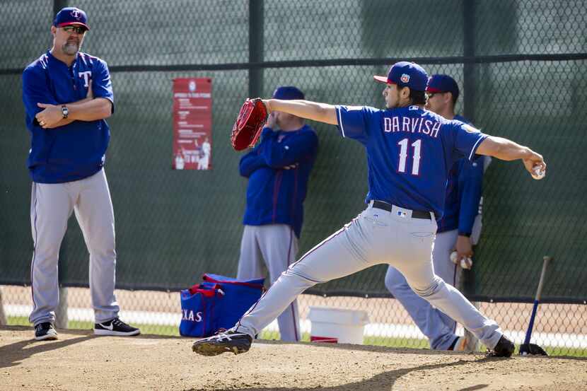 Texas Rangers pitcher Yu Darvish throws off a pitching mound in the bullpen as pitching...