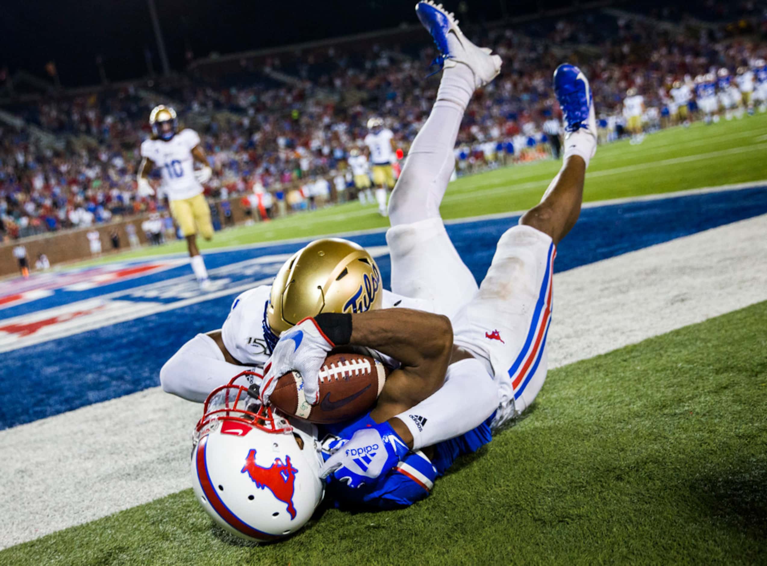 SMU Mustangs wide receiver James Proche (3) falls to the ground after catching a pass in the...