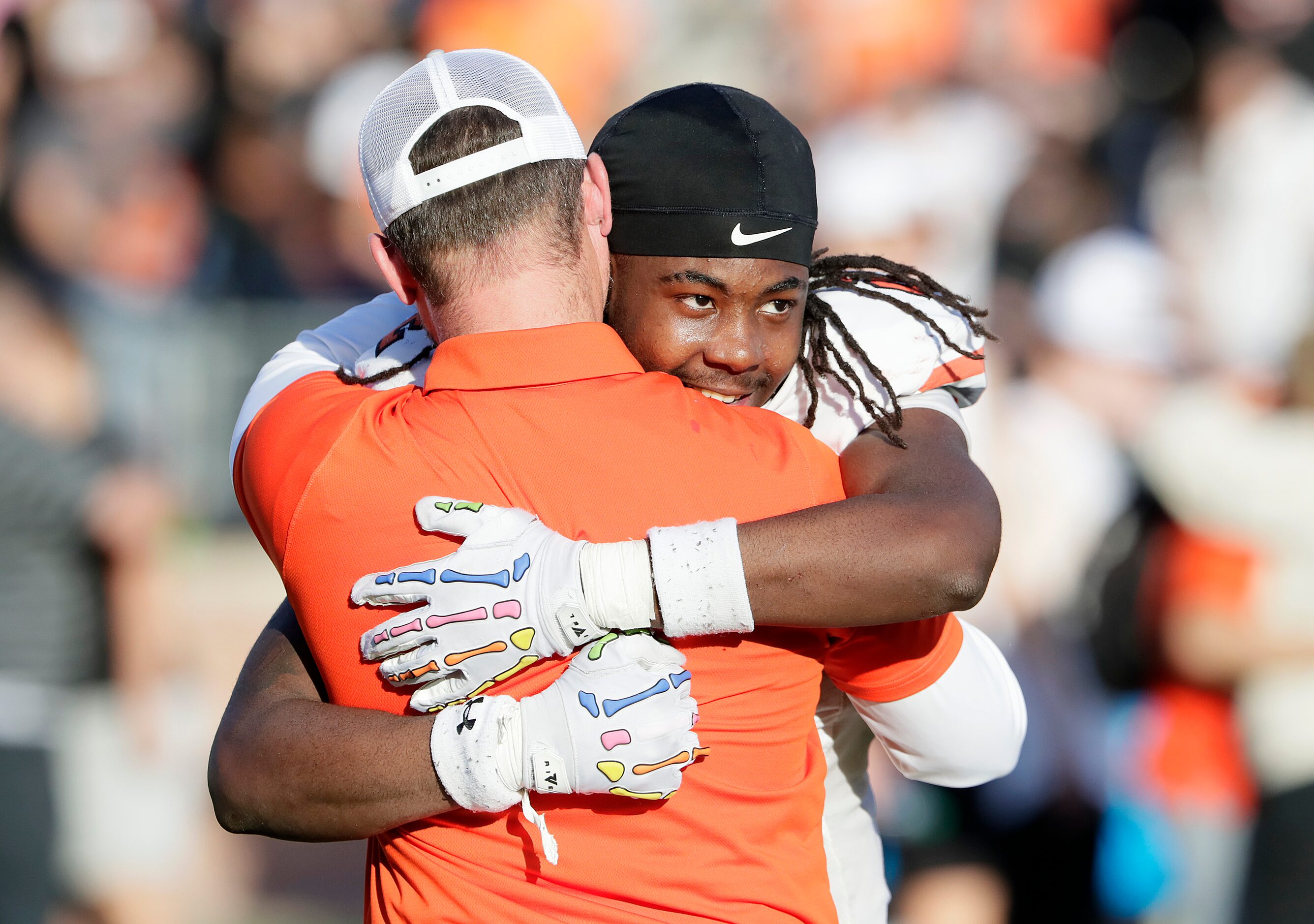 Rockwall High School running back Ashten Emory (2) is embraced by his head coach Trey Brooks...