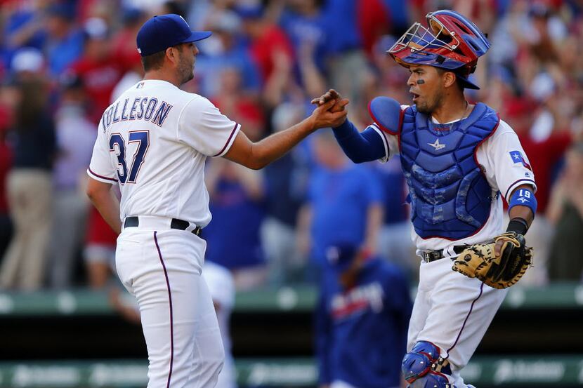 Texas Rangers relief pitcher Shawn Tolleson (37) is congratulated by catcher Robinson...