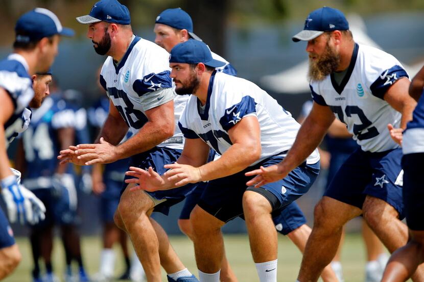 The offensive line including tackle Doug Free (68), guard Zack Martin (70) and center Travis...