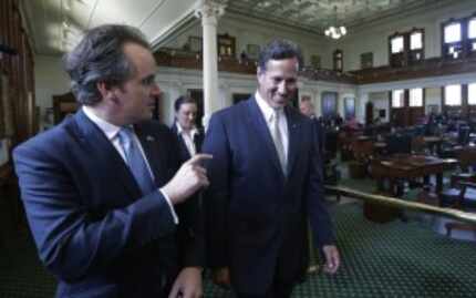  Rep. Bryan Hughes, R-Mineola, (left) walks through the Texas Senate chamber with former...